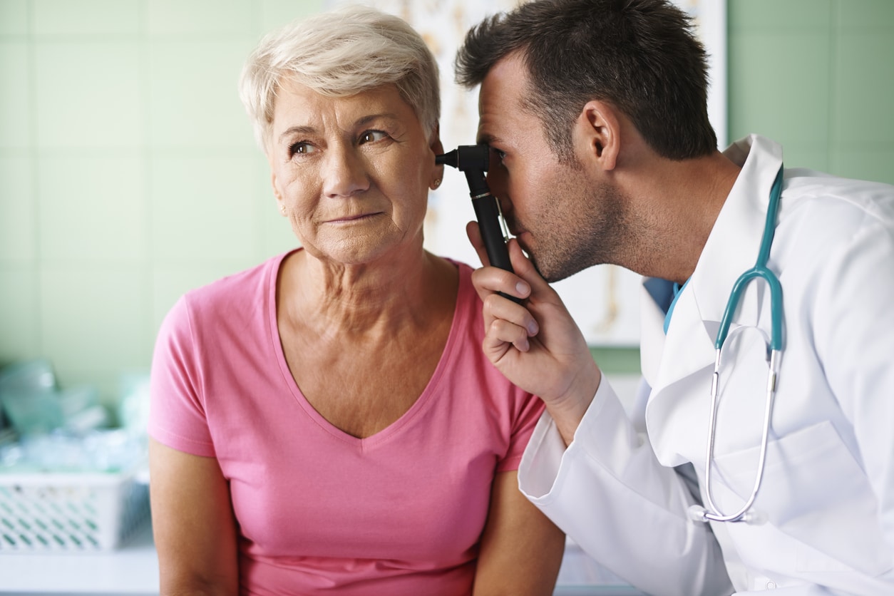 ENT examining his patient's ear